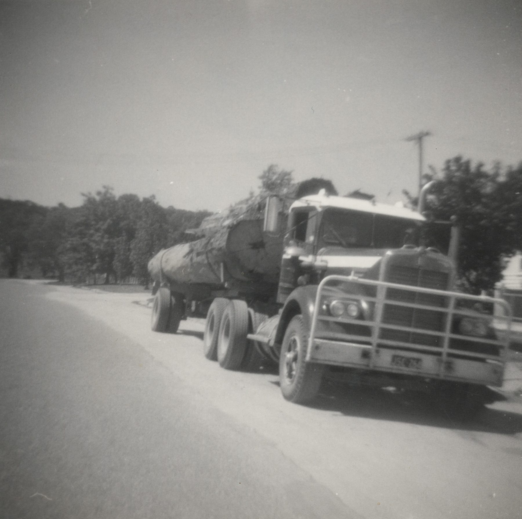 Log truck and trailer combination, High Country backdrop, late 1960s